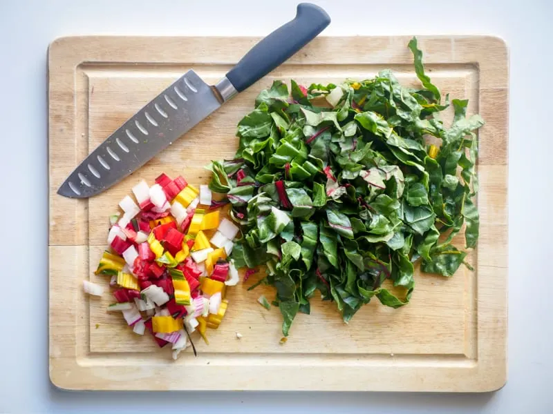 chopped rainbow chard on a wooden cutting board.