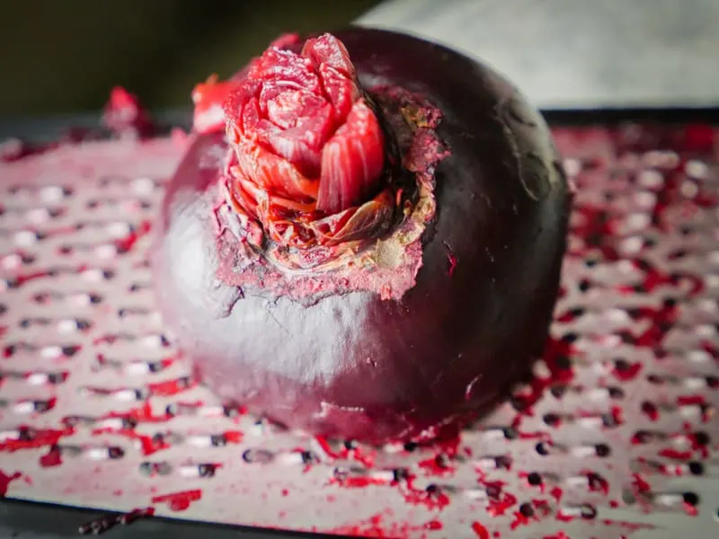 Grating a boiled beet on a box grater