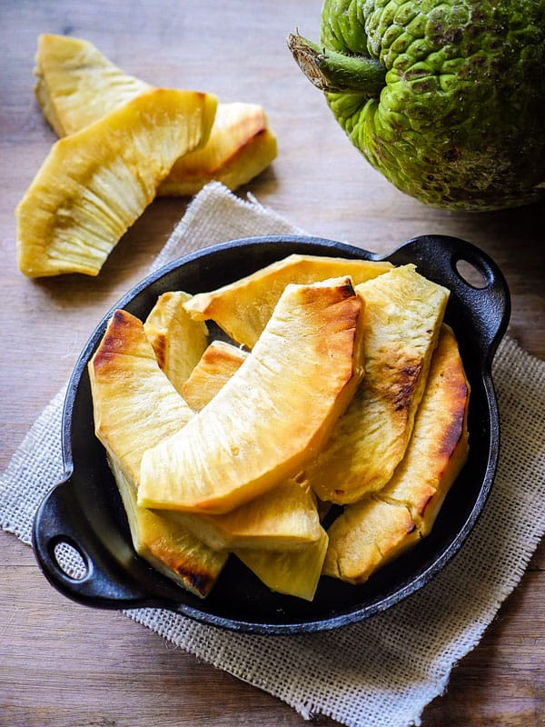 Styled shot of Roasted and fried breadfruit on a wooden table