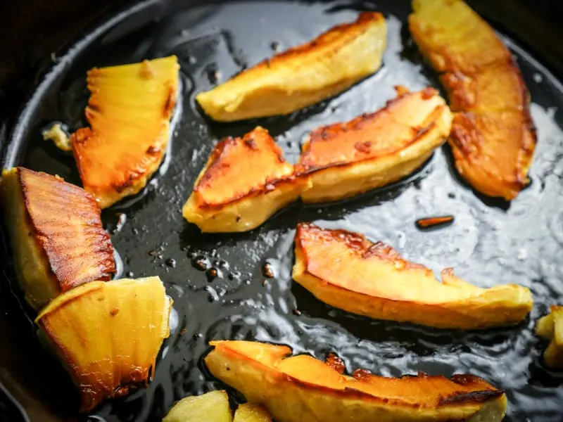 breadfruit frying in a cast iron skillet