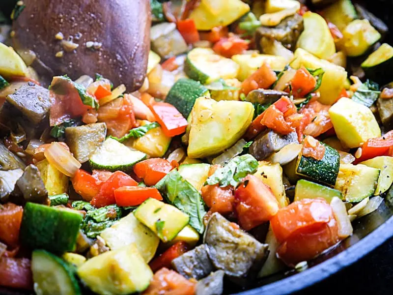 Image of simmering ratatouille in a cast iron skillet.