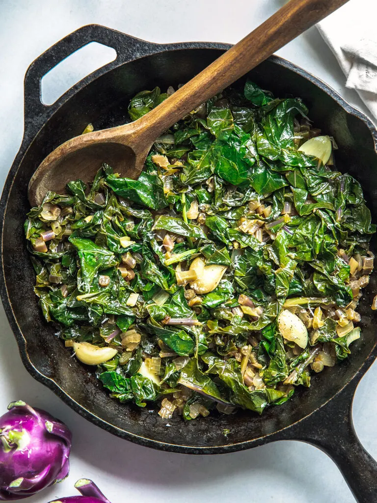 Braised Kohlrabi Greens in a cast iron skillet