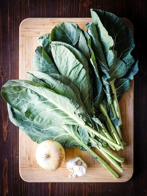 Image of fresh collard greens on a cutting board.